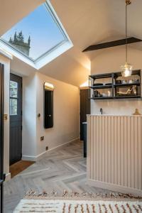 a living room with a skylight in the ceiling at Chic Cotswold Tiny Home - Oddity House in Blockley