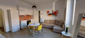 a living room with a table and chairs and a couch at Alba Roma Holiday Home in Rome
