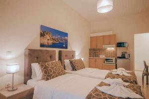 a bedroom with two beds and a kitchen at BELLA De LUX APTS in Ýpsos