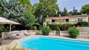 a villa with a swimming pool in front of a house at Villa Linda in Margon