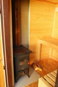 a wood stove in a room in a cabin at Nature Center Údolí volavek II in Weseritz +8 photos