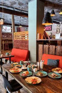 a wooden table with plates of food on it at New Gudauri Lofts by Gudauri Travel in Gudauri