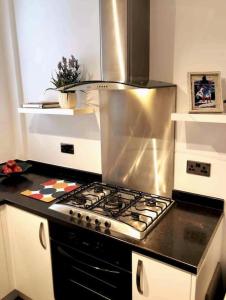 a kitchen with a stove top oven in a kitchen at Sunny Seaside Beach House Lytham Centre sleeps 8 in Lytham St Annes