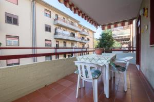 un balcón con mesa y 2 sillas y un edificio en Happy Home, en Taormina