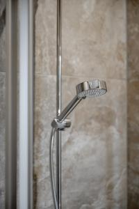a shower with a shower head in a bathroom at Camping Sölden Apartments in Sölden +27 photos