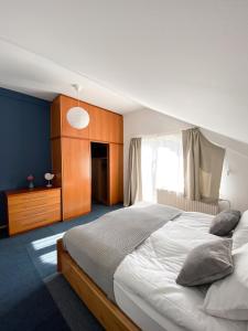 a bedroom with a large bed and a window at Fado Apartments Lendava in Lendava