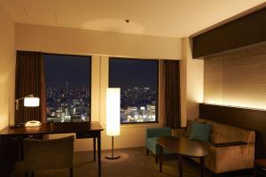 a hotel room with a desk and a view of a city at Keio Plaza Hotel Tokyo in Tokyo