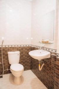 a bathroom with a toilet and a sink at Sunna Hotel in Da Nang