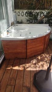 a bath tub sitting on top of a wooden floor at Flatguest - Glass House in Santa Brígida
