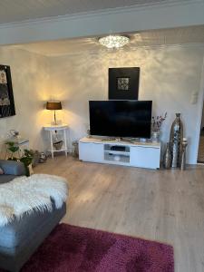 a living room with a large flat screen tv at Familievennlig leiligheten leies ut på Sørlandet. in Vennesla