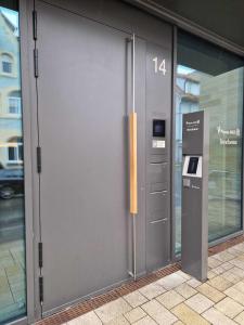 a large metal door of a building with a parking meter at limehome Rottenburg am Neckar Poststraße in Rottenburg