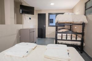 a room with two bunk beds and a television at Hostel Marilian in Salta