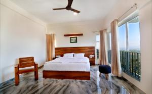a bedroom with a bed and a balcony at 10 Degrees North By Avni Holidays in Idukki