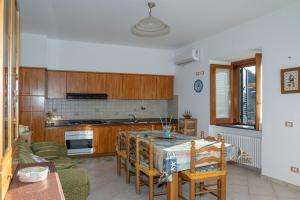 a kitchen with a table and chairs in a room at Sole Holiday House Pontone Holiday house in Pontone