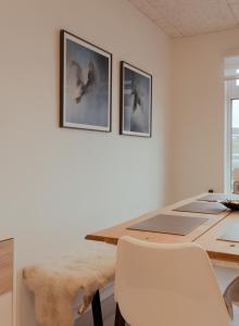 a dining room with a table with a chair and two pictures at Unique Boathouse - Central - Kajak - Fitness in Strendur