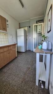 a kitchen with a refrigerator and a table in it at Departamento en increíble ubicación in Mendoza