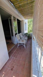 a porch with two chairs and a table at Departamento en increíble ubicación in Mendoza