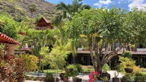 a resort with trees and a mountain in the background at Casa de la Abuela in Ajijic