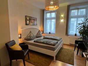 a bedroom with a bed and a chandelier at Pension-Leipzig-Süd in Leipzig