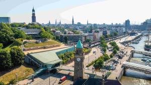 a clock tower in the middle of a city at Jugendherberge Hamburg Auf dem Stintfang-Membership required in Hamburg