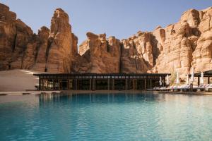 a hotel in the desert next to a mountain at Habitas AlUla in Al Ula