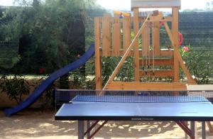 a playground with a wooden chair and a slide at Camping Serenella in Rodi Garganico