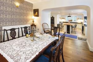 a dining room and living room with a table and chairs at Ty Bledrws - family retreat near the Cardigan Bay coast 