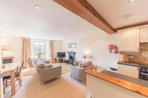 a kitchen and living room with a table and chairs at Tanderra Coniston in Coniston