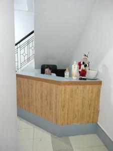 a woman sitting at a counter in a room at Lojed Sean bed and space in Manila