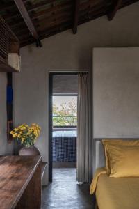 a bedroom with a bed and a window at Dechiu in Hoi An