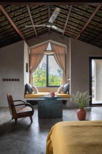 a bedroom with a couch in front of a window at Dechiu in Hoi An
