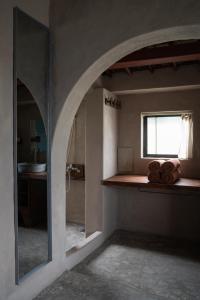a room with a window and a counter with a mirror at Dechiu in Hoi An