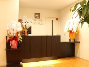 a salon with vases of flowers on a counter at HOTEL LiVEMAX BUDGET Chiba Mihama in Chiba