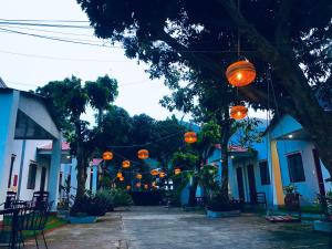 a group of orange lanterns hanging from buildings at Eden House & Coffee Con Dao in Con Dao