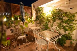 a patio with tables and chairs and plants at Dar Salam - All Inclusive - 2023 Best Hospitality Award in Marrakesh