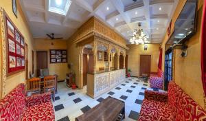an empty restaurant with red chairs and a table at Hotel Akashdeep - Located City Centre in Jaisalmer