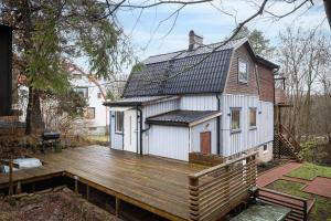 a house with a wooden deck in the yard at the Little Oasis In Gothenburg in Gothenburg