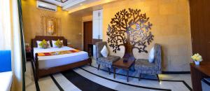 a bedroom with a bed and a table and chairs at Hotel Akashdeep - Located City Centre in Jaisalmer
