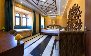 a hotel room with a bed and a table and chairs at Hotel Akashdeep - Located City Centre in Jaisalmer