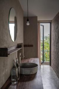 a bathroom with a bath tub and a mirror at Dechiu in Hoi An