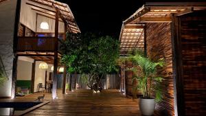 a wooden walkway with potted plants and a building at Akua Bungalows in Marau