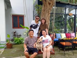 a group of people and a dog on a swing at Eden House & Coffee Con Dao in Con Dao