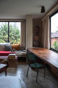 a bedroom with a desk and a bed and a window at Dechiu in Hoi An