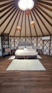 a room with a bed in a yurt at Domos Anulen in Puerto Varas