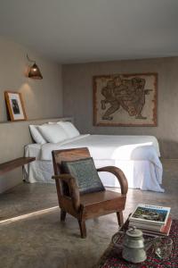 a bedroom with a bed and a table with a chair at Dechiu in Hoi An