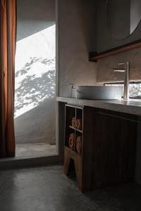a kitchen with a sink and a counter with donuts at Dechiu in Hoi An