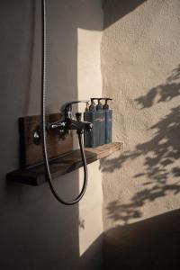 a shower head on a wall in a bathroom at Dechiu in Hoi An