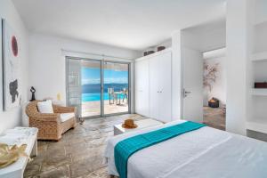 a bedroom with a bed and a view of the ocean at Villa Thalia Floating Heaven in Porto Heli