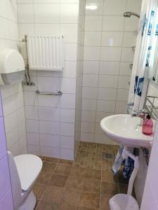 a bathroom with a white sink and a toilet at Stockholm Classic Hotell in Stockholm