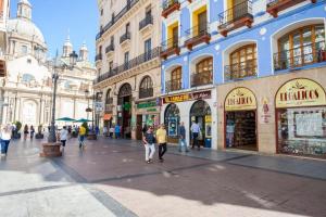 a group of people walking down a city street at Moderno apartamento en casco histórico + desayuno! in Zaragoza